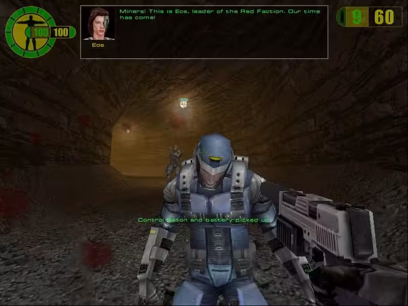 A screenshot from the game Red Faction. Miners are being attacked by guards while someone says on the communication system 'Miners! this is Eos, leader of the Red Faction. Our time has come!'